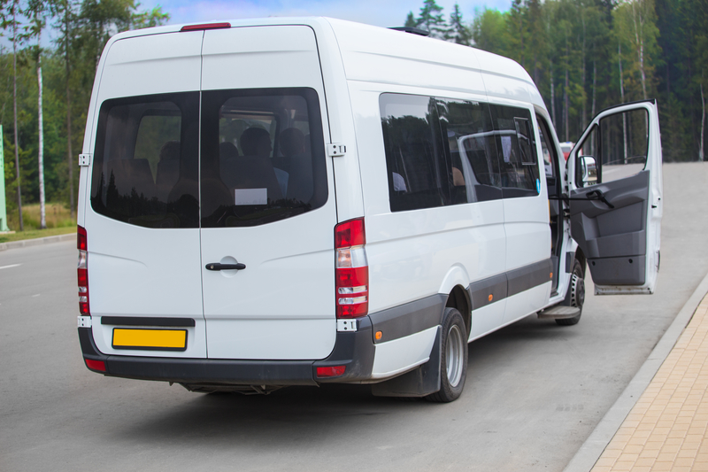 Minibus with an open door at the bus stop